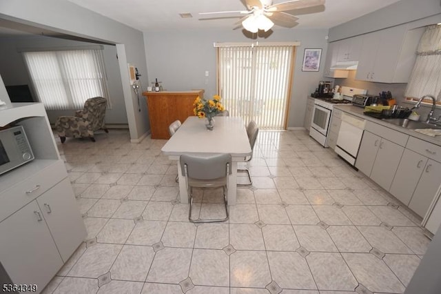 44 Joseph St, Clark Twp, NJ 07066 - kitchen with white appliances, under cabinet range hood, a ceiling fan, and white cabinets