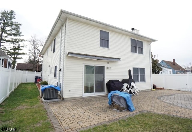 44 Joseph St, Clark Twp, NJ 07066 - back of house featuring a patio area, a fenced backyard, and a chimney