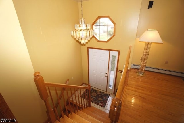44 Joseph St, Clark Twp, NJ 07066 - entryway with a chandelier, wood finished floors, and baseboard heating