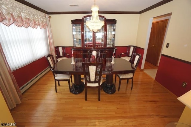 44 Joseph St, Clark Twp, NJ 07066 - dining room with baseboard heating, a chandelier, hardwood / wood-style floors, and crown molding
