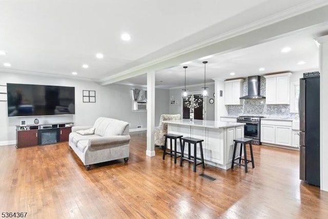 1126-1200 Grant Ave, Plainfield City, NJ 07060 - living area featuring crown molding, wood finished floors, and recessed lighting