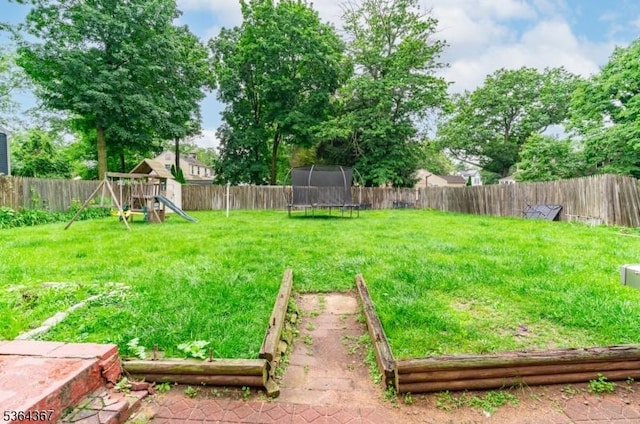 1126-1200 Grant Ave, Plainfield City, NJ 07060 - fenced backyard with a trampoline, a playground, and a vegetable garden