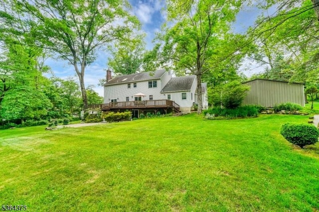 125 Drakestown Rd, Washington Twp, NJ 07853 - rear view of property with a deck, a lawn, and a chimney