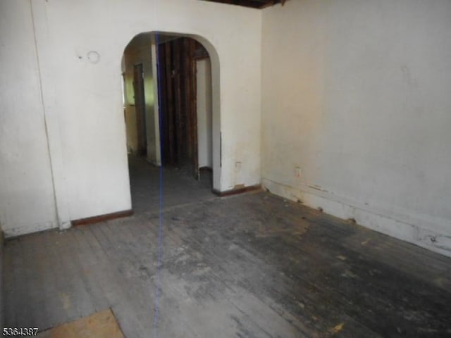 77 Garside St, Newark City, NJ 07104 - spare room featuring arched walkways and wood finished floors