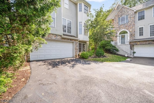 156 Arrowgate Dr, Randolph Twp, NJ 07869 - view of property with stone siding, asphalt driveway, and a garage