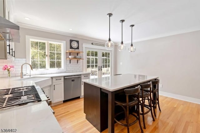 1 Deborah Dr, Morris Twp, NJ 07960 - kitchen with stainless steel dishwasher, light countertops, a kitchen island, decorative backsplash, and a kitchen bar