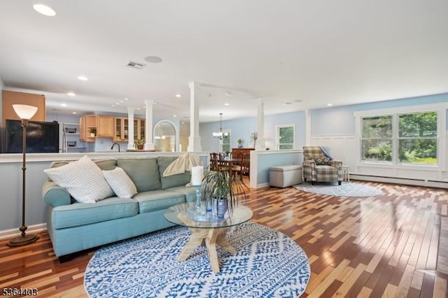 18 Forest Trl, Bernards Twp, NJ 07920 - living room featuring baseboard heating, light wood-style flooring, a chandelier, and recessed lighting