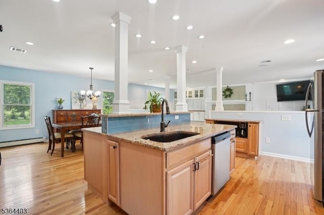 18 Forest Trl, Bernards Twp, NJ 07920 - kitchen featuring decorative columns, stainless steel appliances, a center island with sink, light wood-style floors, and recessed lighting