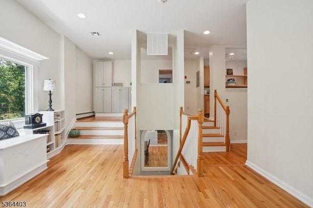 18 Forest Trl, Bernards Twp, NJ 07920 - hallway featuring light wood-style flooring, a baseboard heating unit, recessed lighting, and an upstairs landing