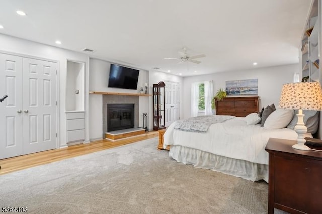 18 Forest Trl, Bernards Twp, NJ 07920 - bedroom featuring recessed lighting, a tile fireplace, wood finished floors, and a ceiling fan