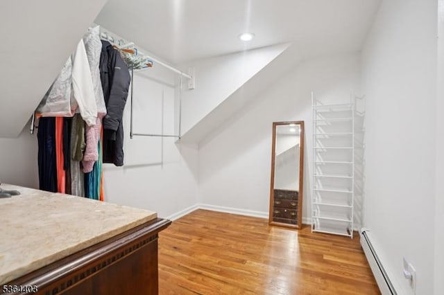 18 Forest Trl, Bernards Twp, NJ 07920 - walk in closet with a baseboard radiator, light wood finished floors, and vaulted ceiling