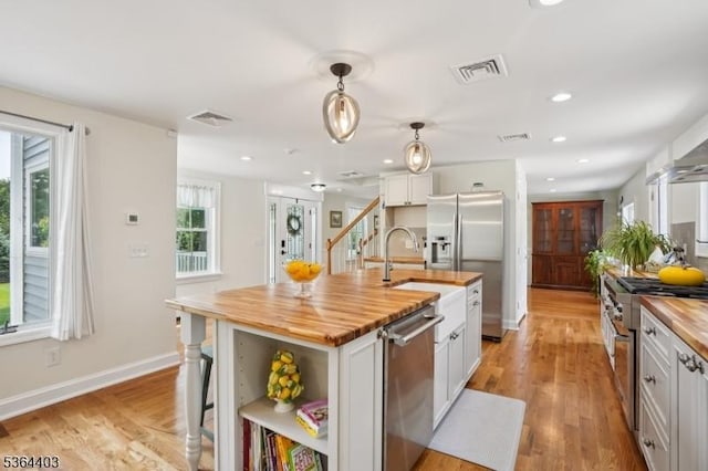 18 Forest Trl, Bernards Twp, NJ 07920 - kitchen with butcher block countertops, stainless steel appliances, open shelves, light wood-style flooring, and recessed lighting