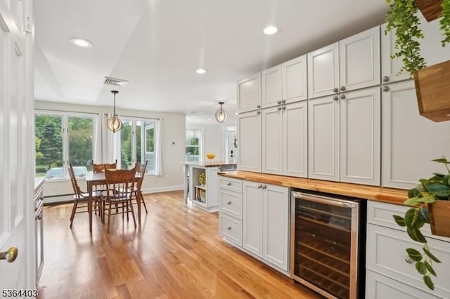 18 Forest Trl, Bernards Twp, NJ 07920 - kitchen with wine cooler, butcher block counters, light wood-style floors, recessed lighting, and decorative light fixtures