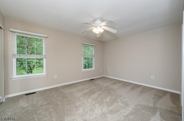 1505 Doolittle Dr, Bridgewater Twp, NJ 08807 - spare room featuring a ceiling fan, plenty of natural light, light colored carpet, and a textured ceiling