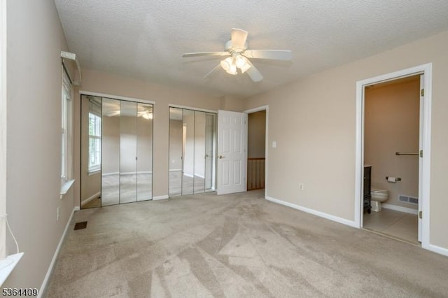 1505 Doolittle Dr, Bridgewater Twp, NJ 08807 - unfurnished bedroom with two closets, light colored carpet, ensuite bathroom, a textured ceiling, and ceiling fan
