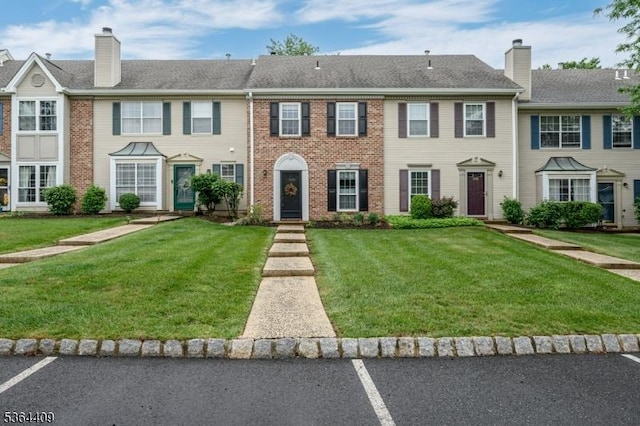 1505 Doolittle Dr, Bridgewater Twp, NJ 08807 - townhome / multi-family property with a chimney, a front yard, brick siding, and uncovered parking