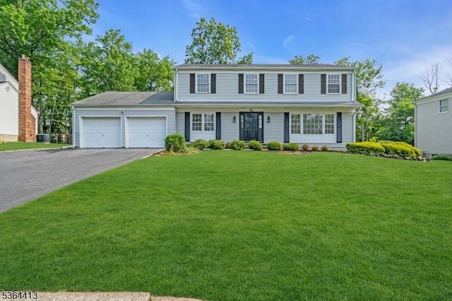 71 Tiffany Dr, East Hanover Twp, NJ 07936 - view of front of property with a garage, asphalt driveway, and a front yard