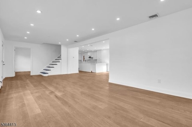 71 Tiffany Dr, East Hanover Twp, NJ 07936 - unfurnished living room featuring recessed lighting, light wood-style floors, and stairway