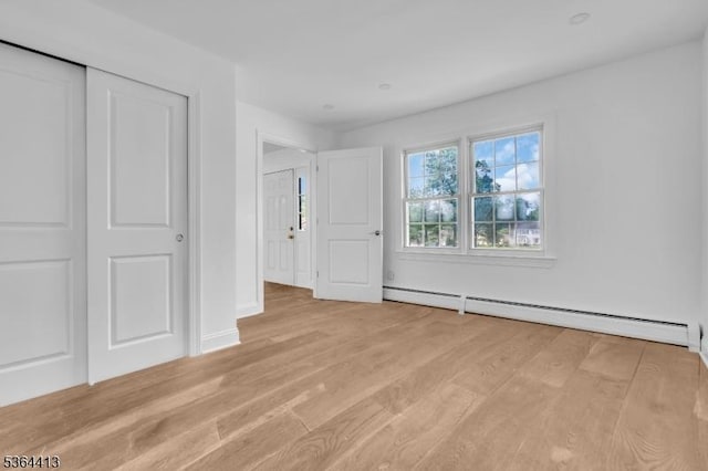 71 Tiffany Dr, East Hanover Twp, NJ 07936 - unfurnished bedroom with a baseboard radiator, light wood finished floors, and a closet