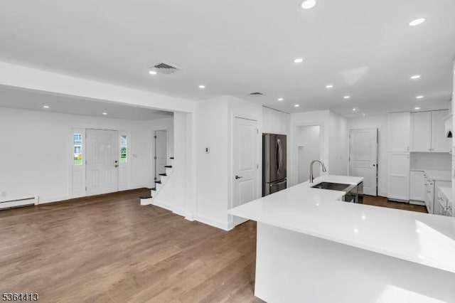 71 Tiffany Dr, East Hanover Twp, NJ 07936 - kitchen with freestanding refrigerator, white cabinets, recessed lighting, wood finished floors, and light countertops