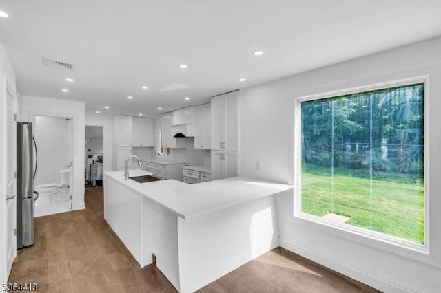 71 Tiffany Dr, East Hanover Twp, NJ 07936 - kitchen with freestanding refrigerator, recessed lighting, white cabinetry, wood finished floors, and light countertops