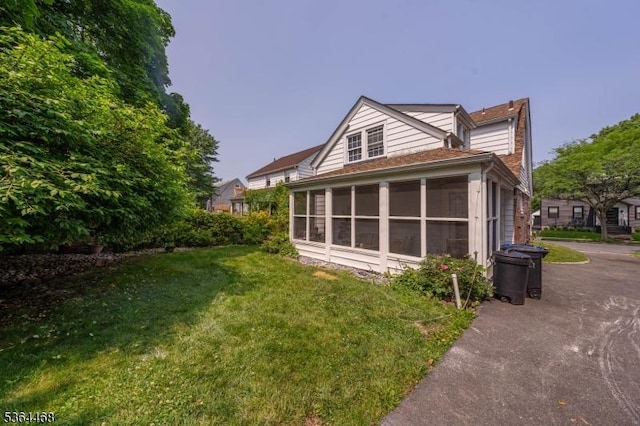 28 Overlook Ter, Maplewood Twp, NJ 07040 - back of house featuring a sunroom and a lawn