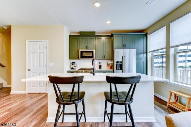 1005 Station Rd, Somerville Boro, NJ 08876 - kitchen with appliances with stainless steel finishes, green cabinets, light countertops, light wood-style flooring, and recessed lighting