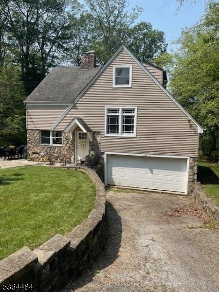 250 Waconia Rd, Vernon Twp, NJ 07422 - view of front of house featuring a chimney, an attached garage, asphalt driveway, and stone siding