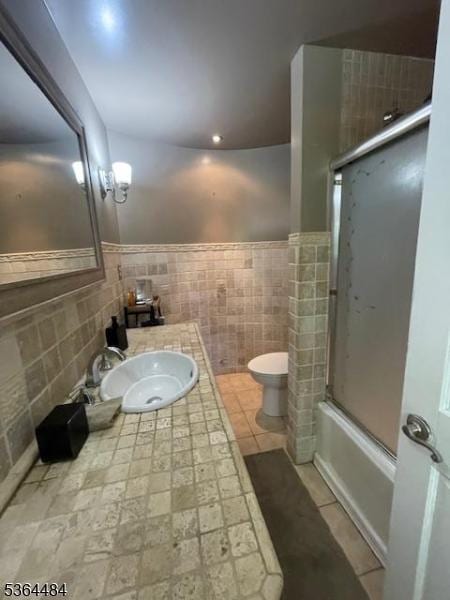 250 Waconia Rd, Vernon Twp, NJ 07422 - bathroom featuring tile walls, vanity, combined bath / shower with glass door, and wainscoting