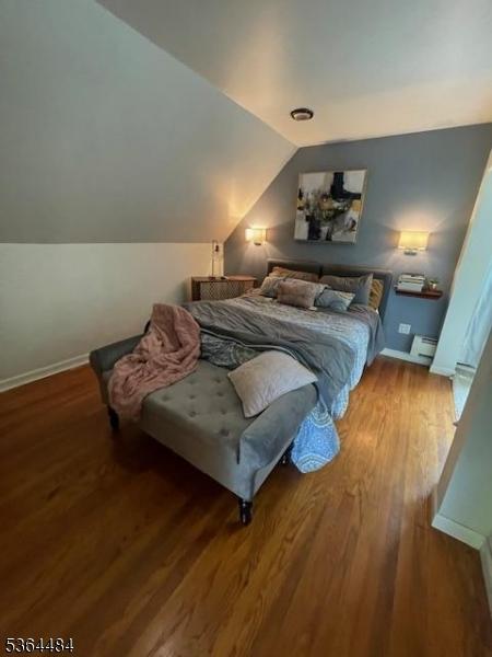 250 Waconia Rd, Vernon Twp, NJ 07422 - bedroom featuring vaulted ceiling, wood finished floors, and a baseboard heating unit