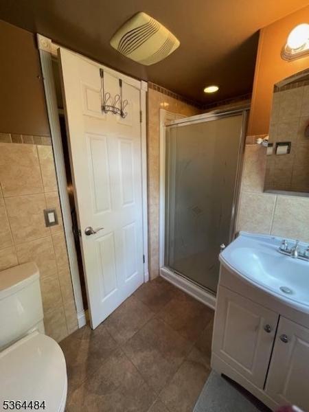 250 Waconia Rd, Vernon Twp, NJ 07422 - bathroom featuring tile walls, vanity, a stall shower, and tile patterned floors