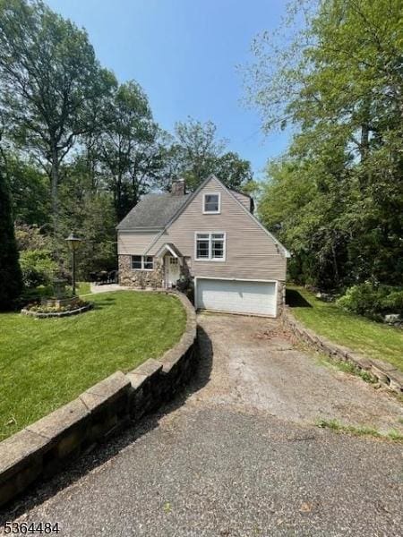 250 Waconia Rd, Vernon Twp, NJ 07422 - view of front facade with an attached garage, asphalt driveway, a chimney, and a front yard