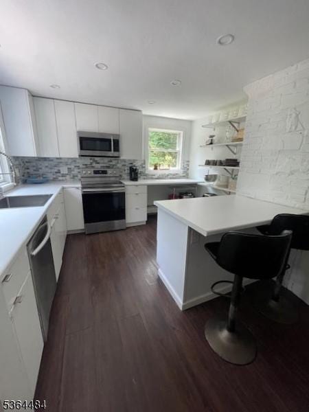 250 Waconia Rd, Vernon Twp, NJ 07422 - kitchen featuring stainless steel appliances, dark wood finished floors, white cabinetry, light countertops, and backsplash
