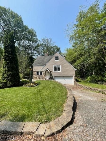 250 Waconia Rd, Vernon Twp, NJ 07422 - view of front of home featuring a garage, dirt driveway, a front yard, stone siding, and a chimney