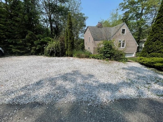 250 Waconia Rd, Vernon Twp, NJ 07422 - view of side of property with a chimney and a garage