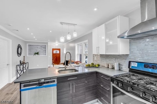 1218 Kline Pl, Rahway City, NJ 07065 - kitchen with appliances with stainless steel finishes, wall chimney exhaust hood, a peninsula, ornamental molding, and white cabinetry