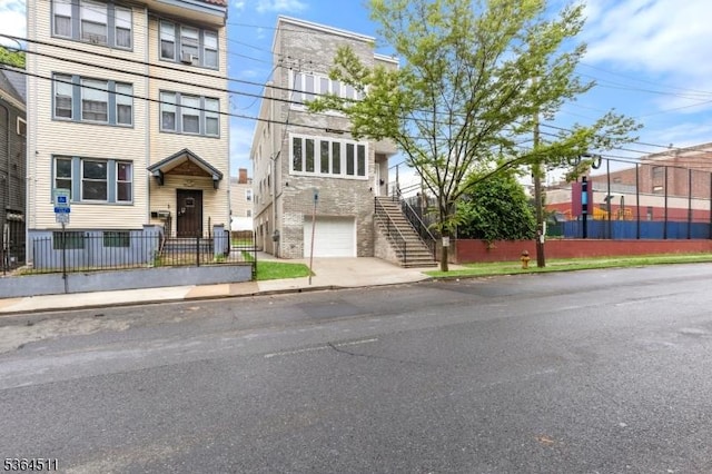 22 Speedway Ave, Newark City, NJ 07106 - view of front of house featuring stairway, a garage, and stone siding