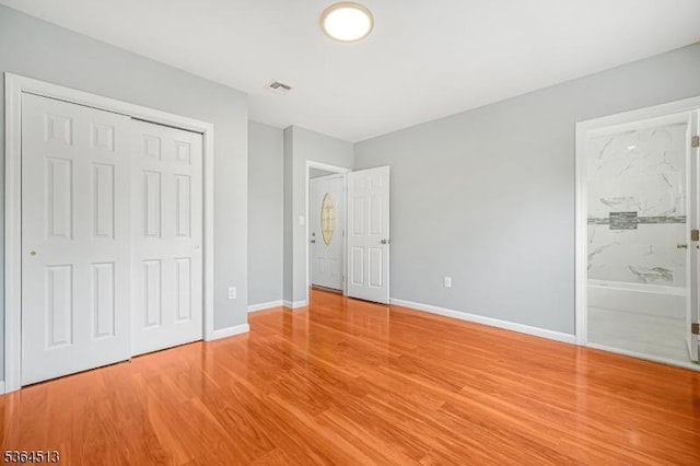 125 Birch St, Bloomfield Twp, NJ 07003 - unfurnished bedroom with wood finished floors, a closet, and connected bathroom