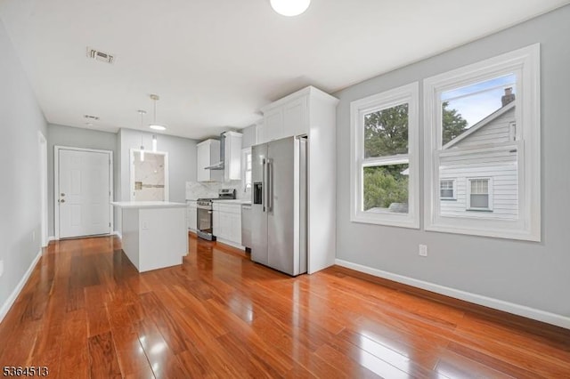 125 Birch St, Bloomfield Twp, NJ 07003 - kitchen with appliances with stainless steel finishes, light countertops, wood-type flooring, and white cabinetry