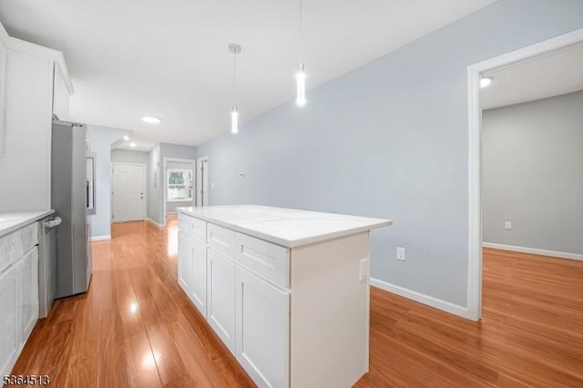 125 Birch St, Bloomfield Twp, NJ 07003 - kitchen featuring light wood-style floors, a center island, white cabinetry, appliances with stainless steel finishes, and pendant lighting