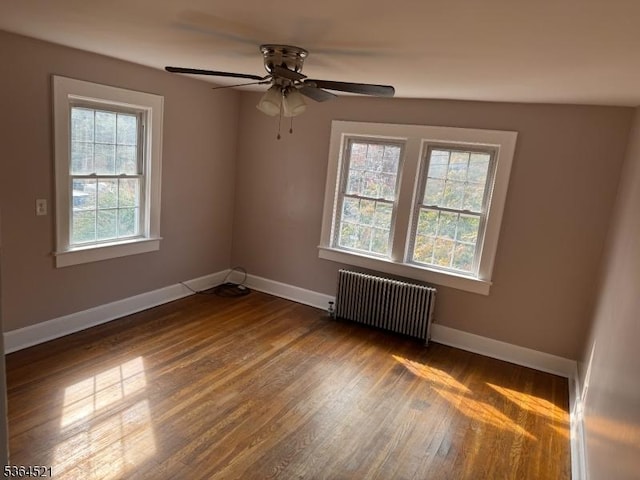 226 N 3rd Ave, Manville Boro, NJ 08835 - unfurnished room featuring radiator heating unit, wood finished floors, and ceiling fan