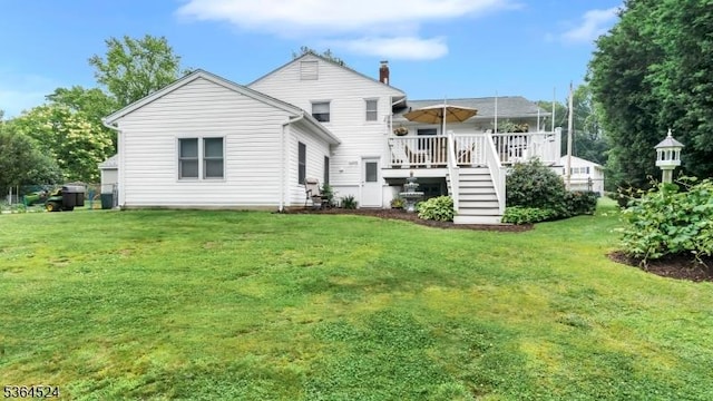 32 Sanford Dr, Randolph Twp, NJ 07869 - back of property with a wooden deck, a yard, and stairway
