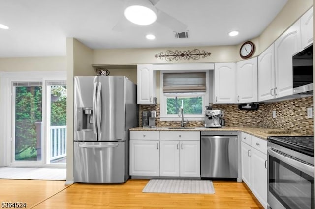 32 Sanford Dr, Randolph Twp, NJ 07869 - kitchen featuring stainless steel appliances, light stone countertops, white cabinetry, and recessed lighting