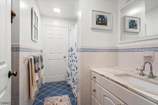 31 Somerville Rd, West Milford Twp, NJ 07421 - full bath with tile walls, tile patterned floors, vanity, a wainscoted wall, and a shower with shower curtain