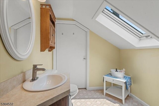 31 Somerville Rd, West Milford Twp, NJ 07421 - bathroom with a skylight, vaulted ceiling, and vanity