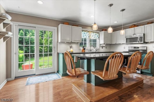 31 Somerville Rd, West Milford Twp, NJ 07421 - kitchen with stainless steel microwave, tasteful backsplash, ornamental molding, hanging light fixtures, and dark countertops