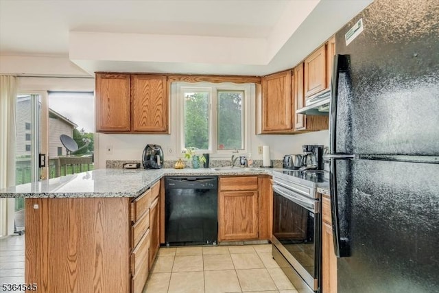 312 Cheyenne Rd Unit 312, Andover Twp, NJ 07848 - kitchen with black appliances, a peninsula, under cabinet range hood, light tile patterned floors, and light stone countertops