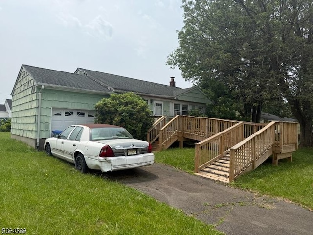 397 Lake Ave, Woodbridge Twp, NJ 07067 - view of front facade with an attached garage, stairway, a front yard, and asphalt driveway