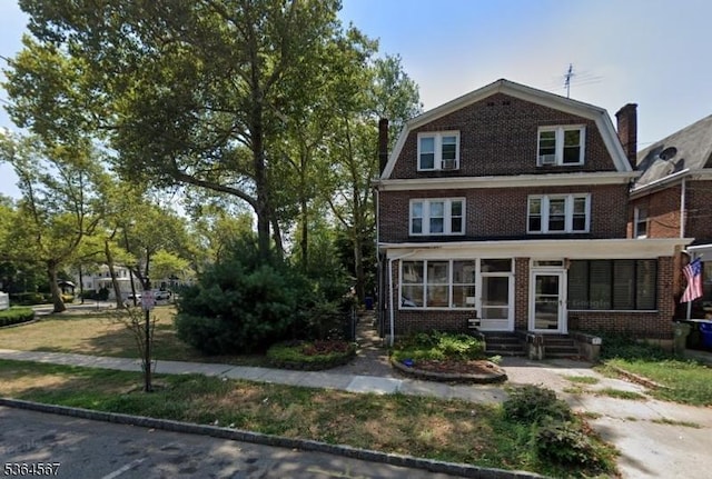 69 Lewis St, Perth Amboy City, NJ 08861 - view of front of house with entry steps, a gambrel roof, and brick siding