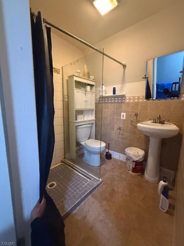 69 Lewis St, Perth Amboy City, NJ 08861 - bathroom with tile walls, a shower stall, a wainscoted wall, and tile patterned flooring